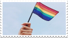 hand holding gay flag stamp